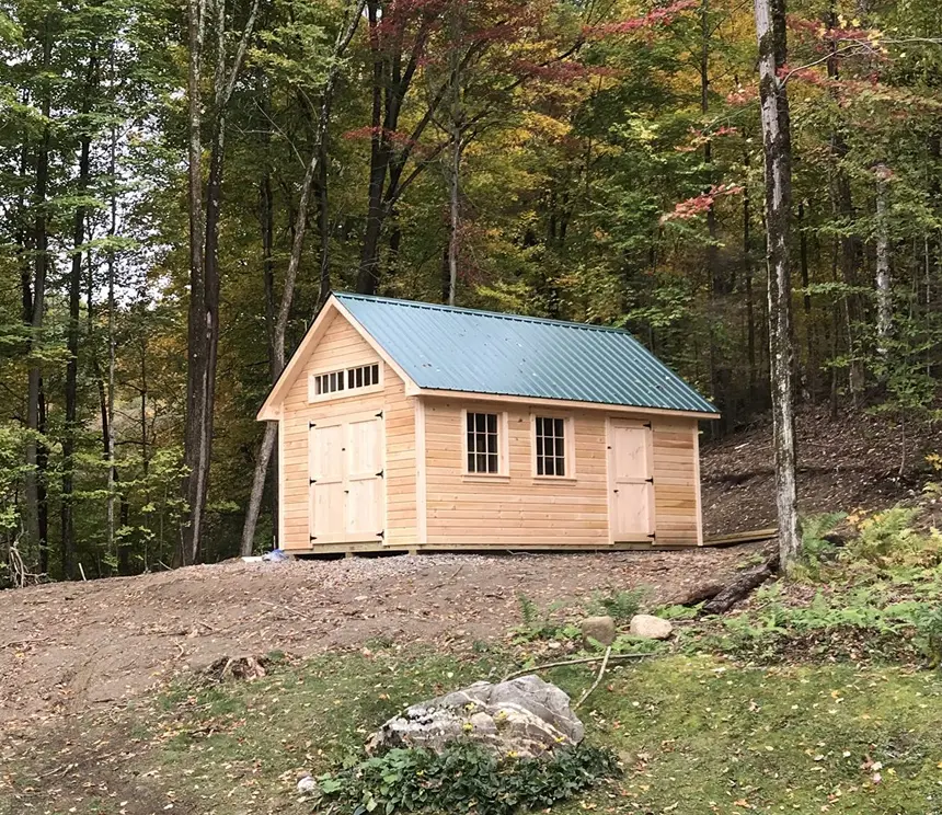 a large custom shed with two sets of doors, window, and metal roof upgrades